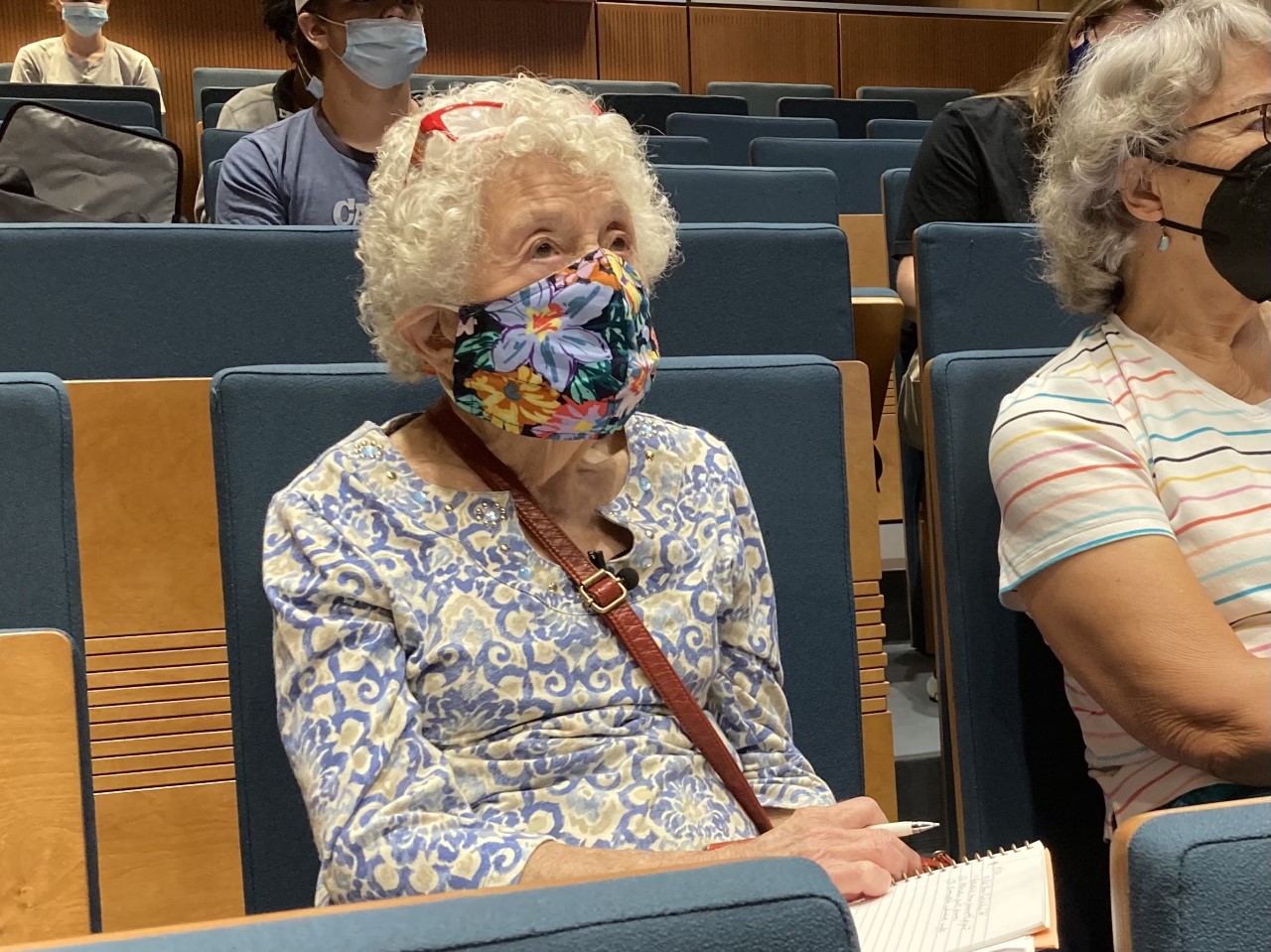 101-year-old Ruth Thompson sits in college lecture hall wearing mask