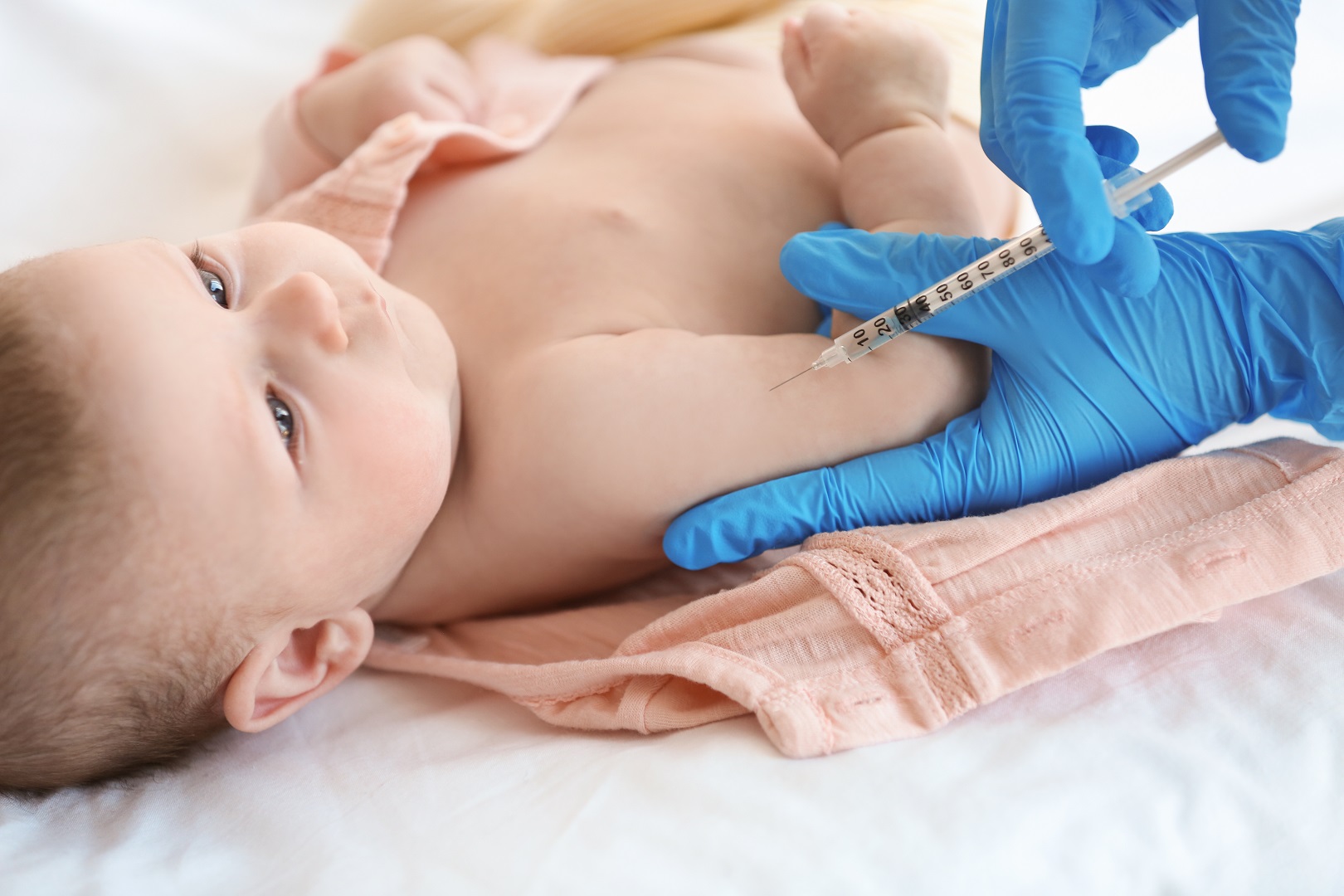 Blue Gloves Give Baby Vaccine