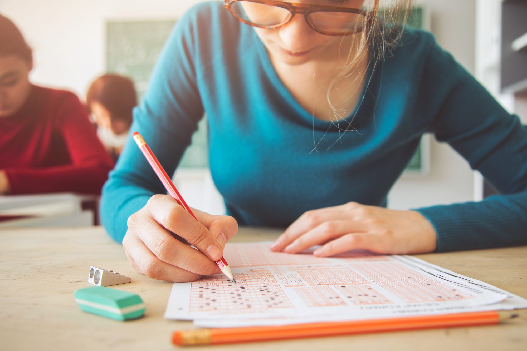 An image of a teenage girl taking a test.