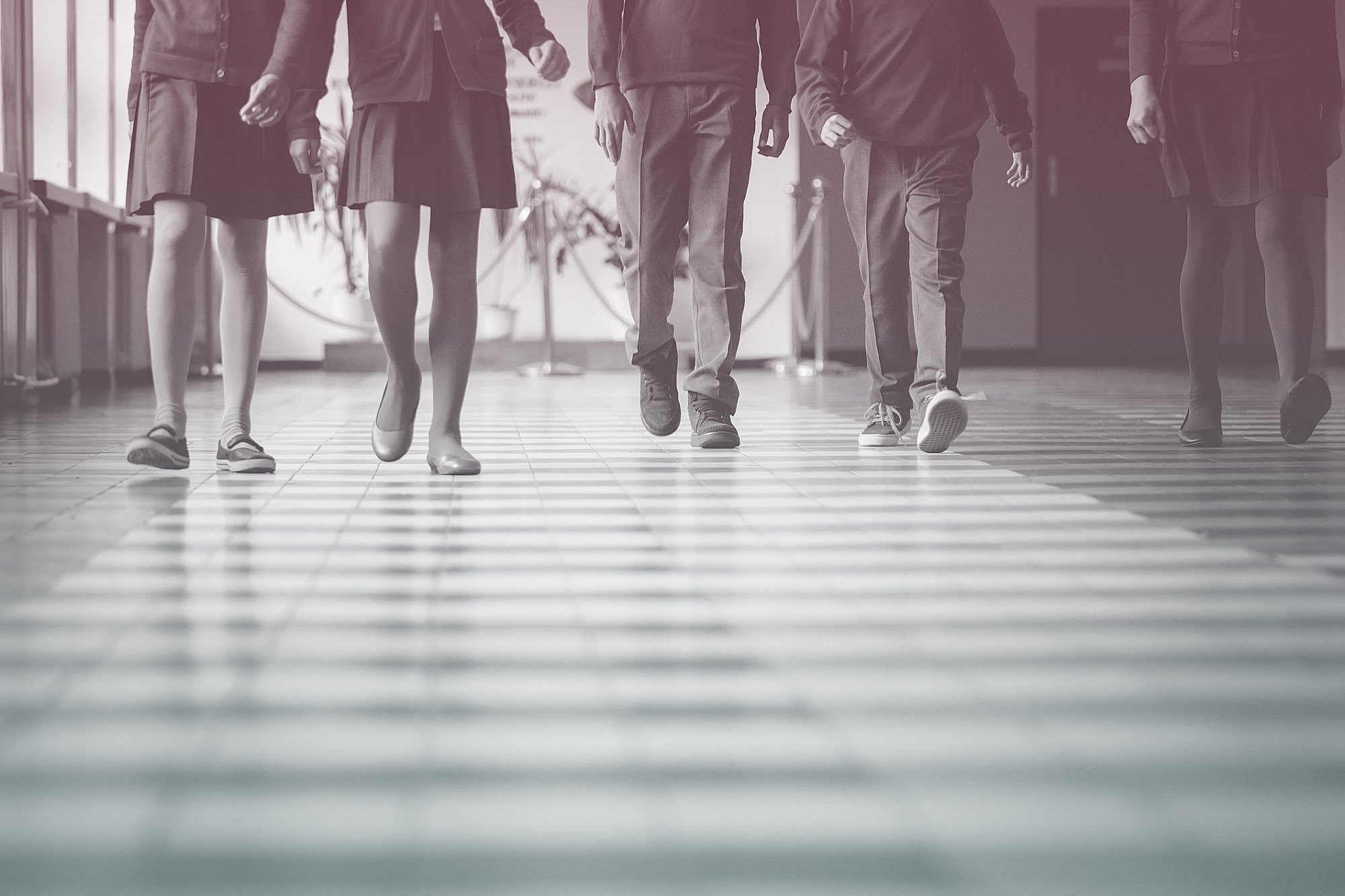 Group of students walking through school hallway