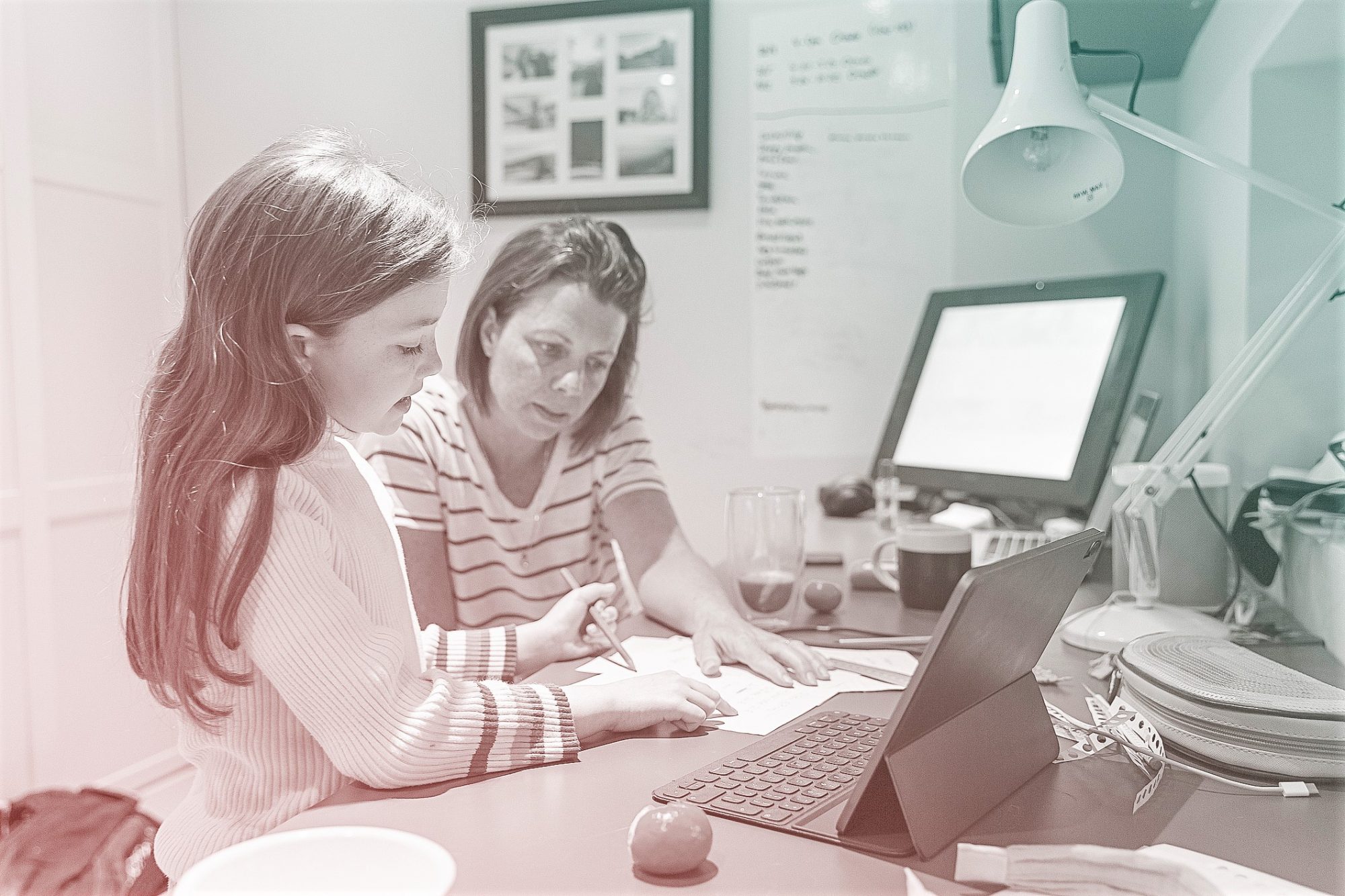 Woman helping daughter with her home schooling