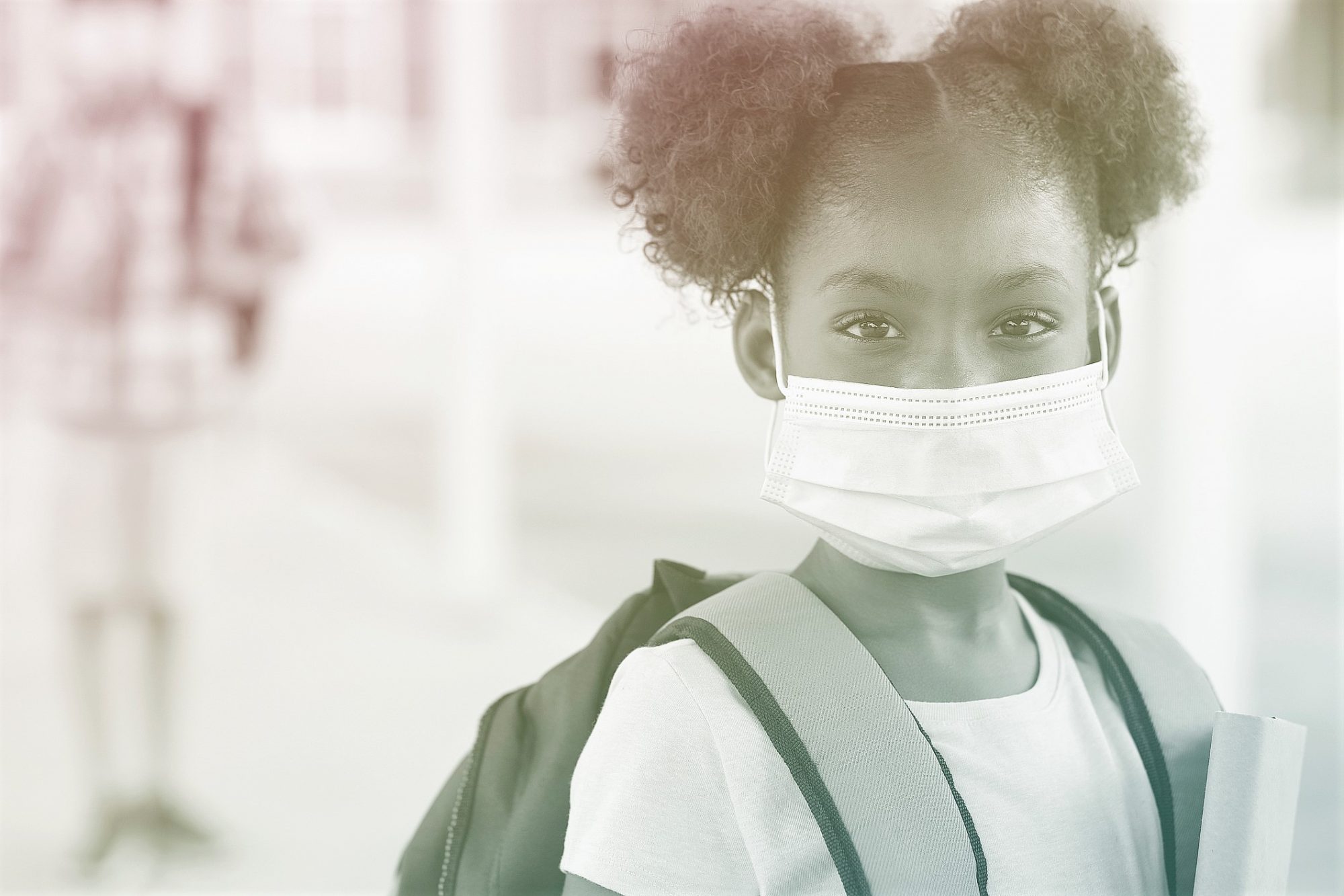 student wearing backpack and face mask